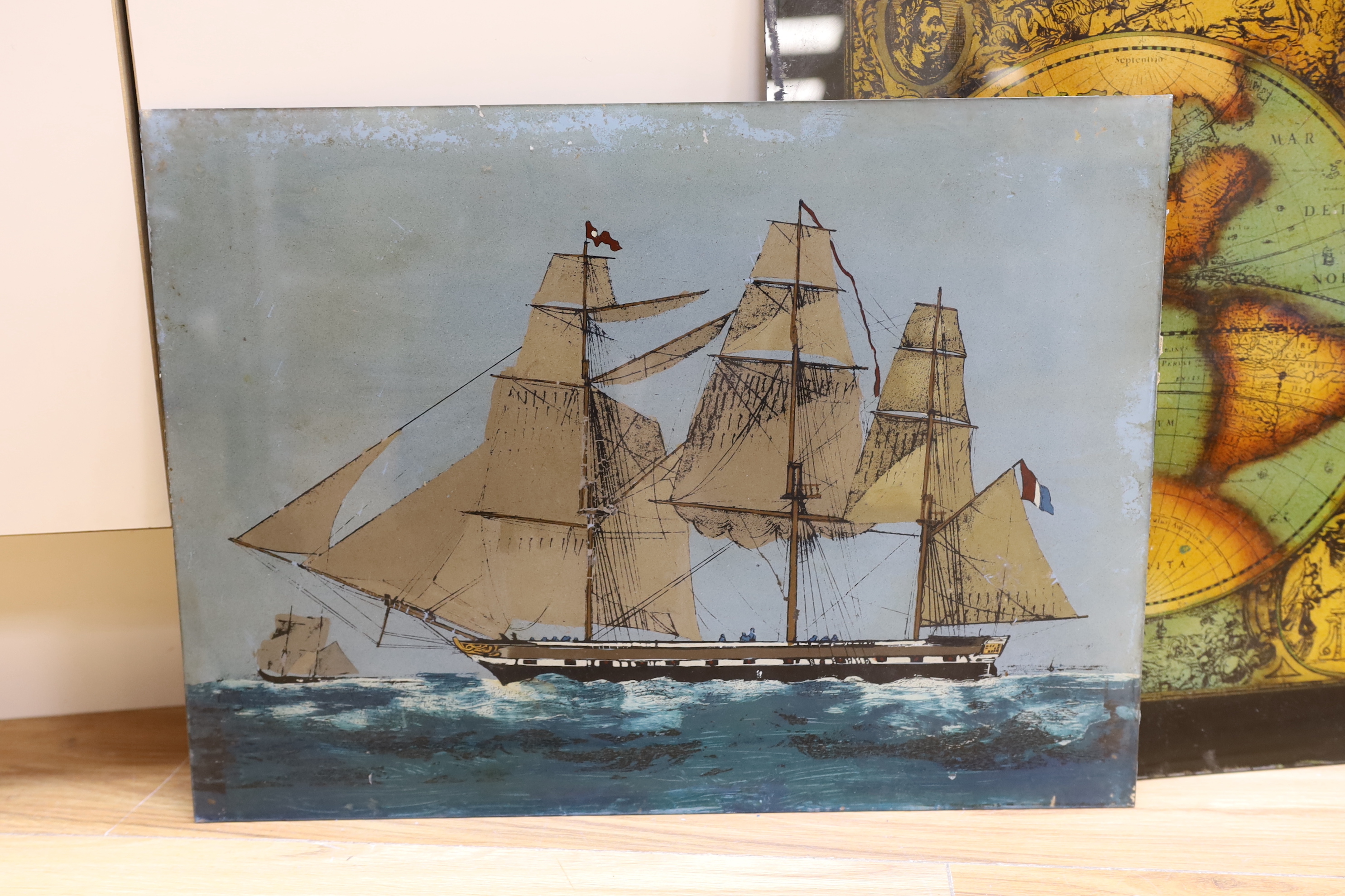 Three reverse painted glass panels, two of sailing ships and another map of the world- 62cm wide x 47cm high